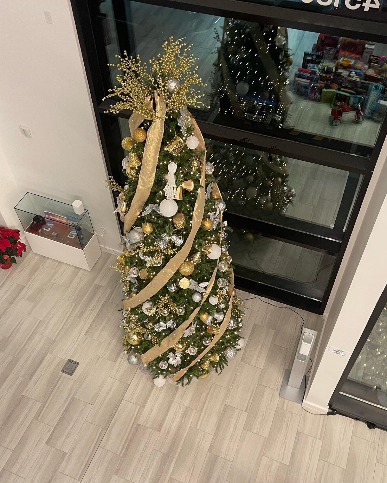 Entry tree with gold ribbon, gold and silver ornaments