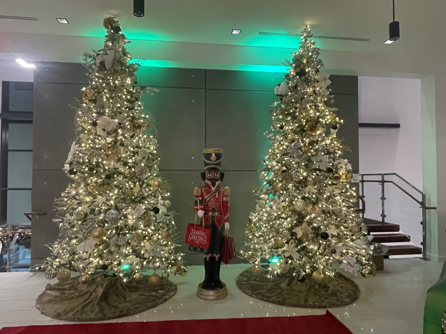 Pair of flocked trees with a life-size nutcracker